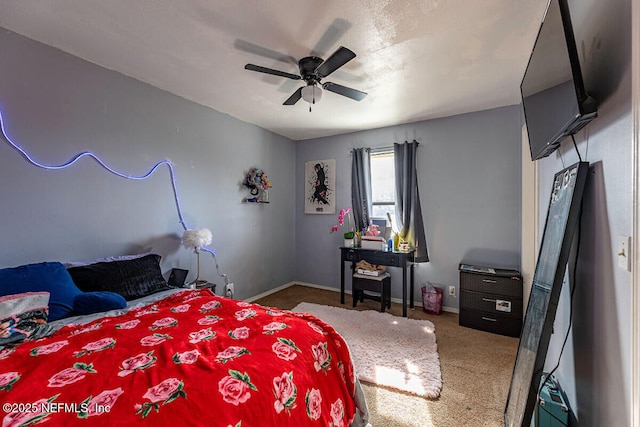 bedroom with dark colored carpet and ceiling fan