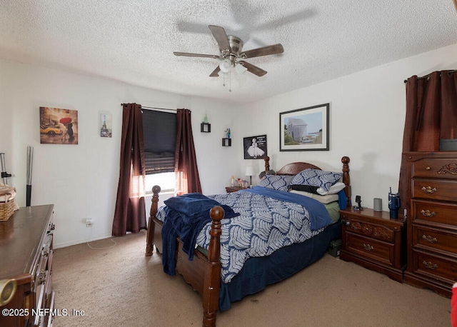 bedroom with ceiling fan, light colored carpet, and a textured ceiling