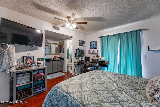 bedroom with ceiling fan, dark hardwood / wood-style flooring, and a textured ceiling