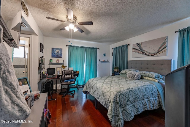 bedroom with a textured ceiling, dark wood-type flooring, and ceiling fan