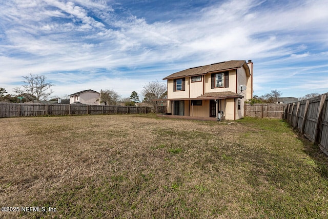 rear view of house with a lawn