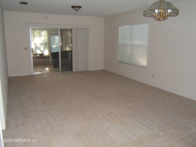 9252 San Jose Blvd Unit 3701, Jacksonville, FL 32257 - empty room with carpet flooring and a chandelier