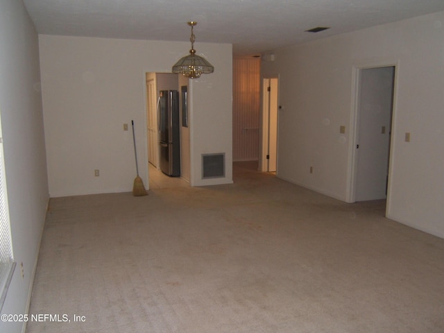 9252 San Jose Blvd Unit 3701, Jacksonville, FL 32257 - empty room featuring a chandelier and light colored carpet