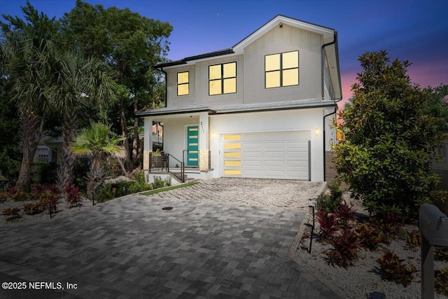 211 Belvedere St, Atlantic Beach, FL 32233 - contemporary house with a garage, decorative driveway, covered porch, and board and batten siding
