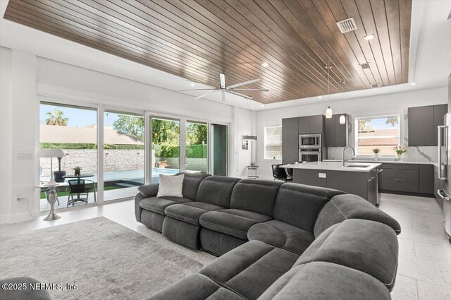 211 Belvedere St, Atlantic Beach, FL 32233 - living room featuring wooden ceiling, ceiling fan, and baseboards