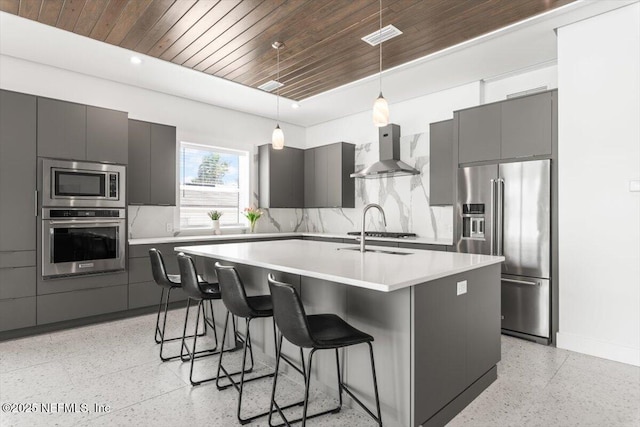 211 Belvedere St, Atlantic Beach, FL 32233 - kitchen featuring stainless steel appliances, wall chimney range hood, dark speckled floor, wood ceiling, and modern cabinets