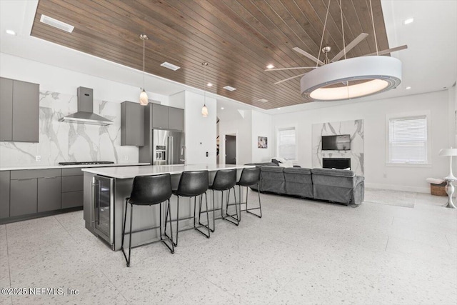 211 Belvedere St, Atlantic Beach, FL 32233 - kitchen featuring wall chimney range hood, gray cabinetry, high end fridge, wooden ceiling, and a kitchen breakfast bar