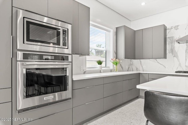 211 Belvedere St, Atlantic Beach, FL 32233 - kitchen featuring gray cabinetry, appliances with stainless steel finishes, modern cabinets, and dark speckled floor