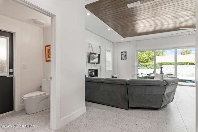 211 Belvedere St, Atlantic Beach, FL 32233 - living room with speckled floor, baseboards, a fireplace, and recessed lighting