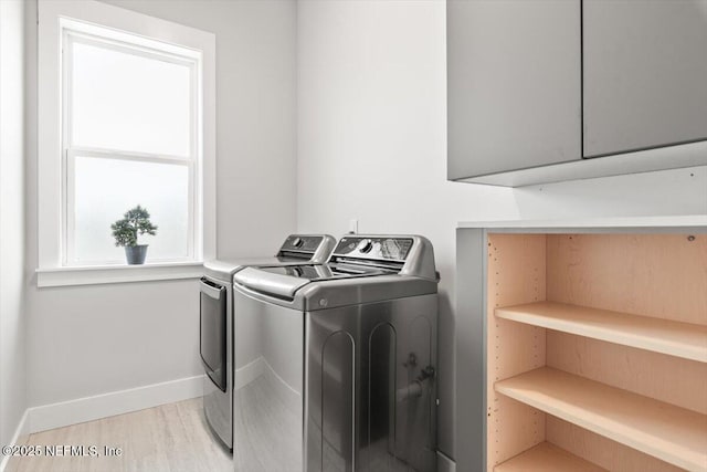 211 Belvedere St, Atlantic Beach, FL 32233 - laundry room featuring washing machine and dryer, cabinet space, baseboards, and light wood-style flooring
