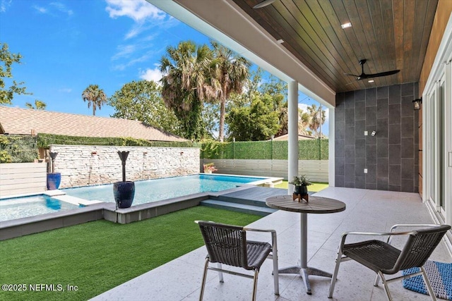 211 Belvedere St, Atlantic Beach, FL 32233 - fenced backyard with a ceiling fan and a patio