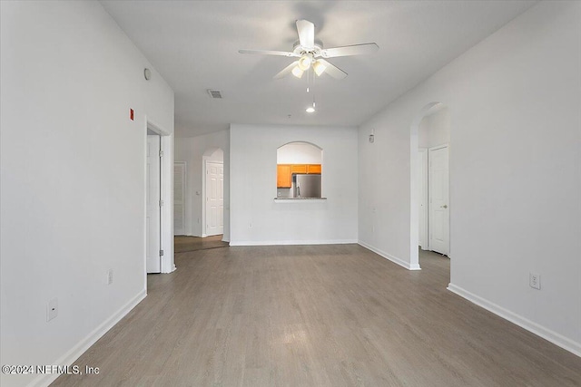 unfurnished room featuring ceiling fan and hardwood / wood-style flooring