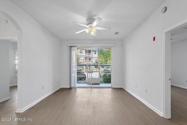 empty room featuring ceiling fan and dark hardwood / wood-style floors