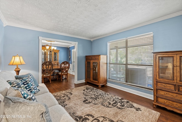 living room with an inviting chandelier, ornamental molding, dark hardwood / wood-style floors, and a textured ceiling