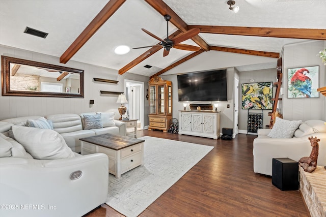 living room featuring dark hardwood / wood-style floors, vaulted ceiling with beams, and ceiling fan