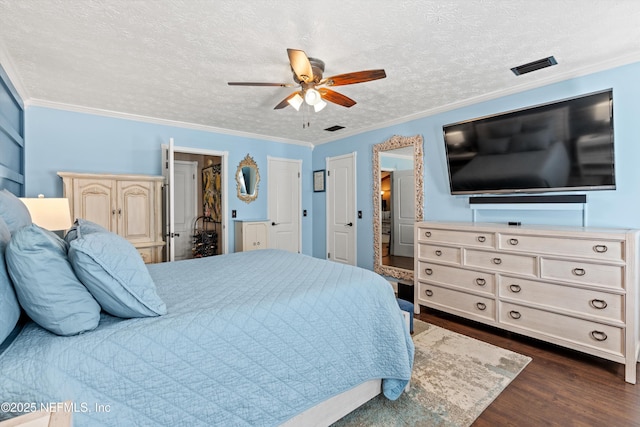 bedroom featuring ornamental molding, dark hardwood / wood-style floors, and a textured ceiling