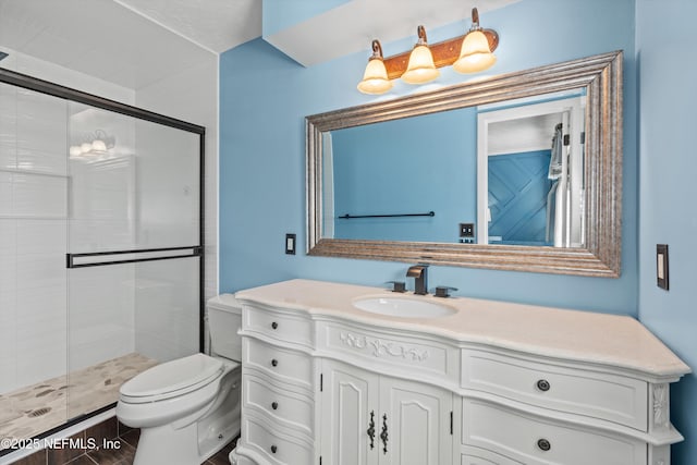 bathroom featuring vanity, toilet, and a shower with shower door