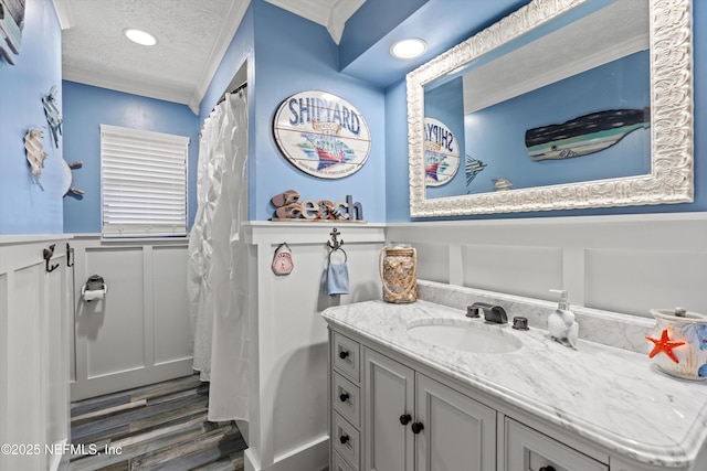 bathroom with crown molding, a textured ceiling, vanity, a shower with shower curtain, and hardwood / wood-style floors