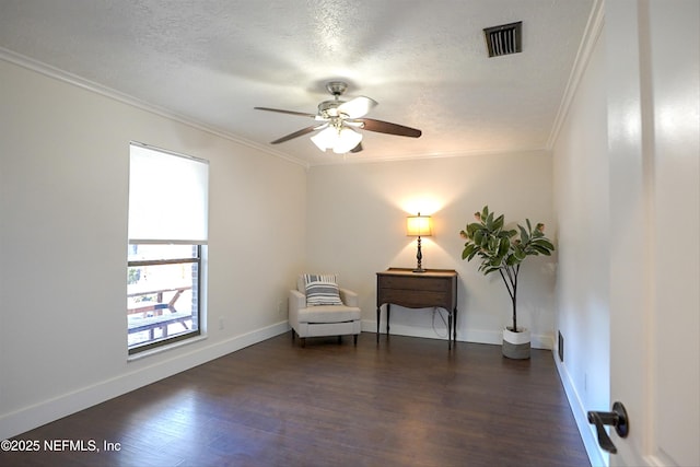 living area with dark hardwood / wood-style flooring, crown molding, and a textured ceiling