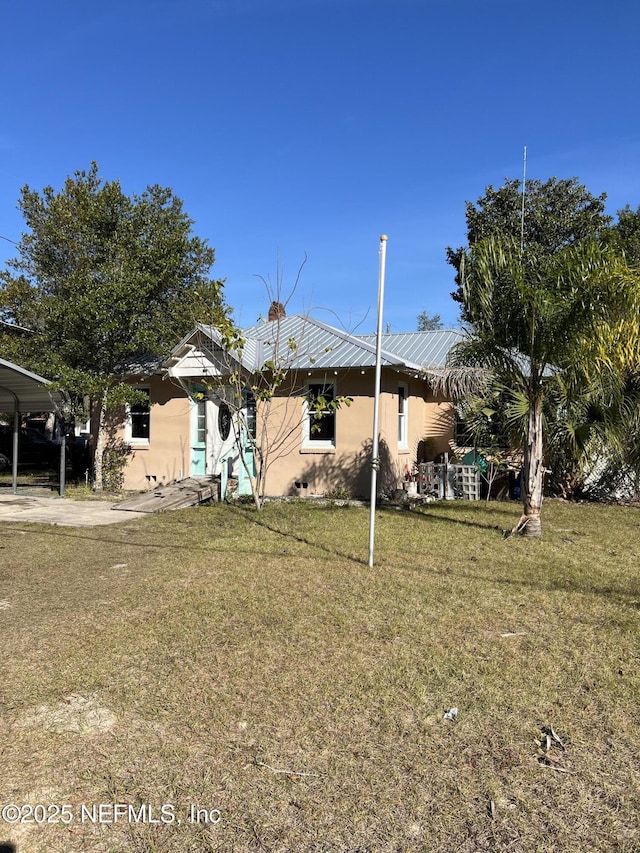 view of front of home featuring a front lawn and a carport