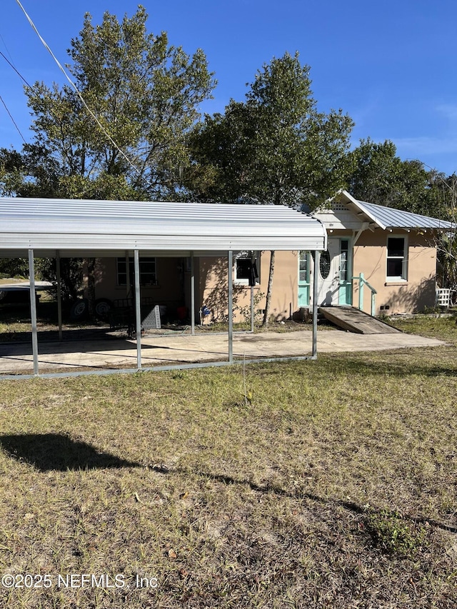 rear view of property featuring a yard