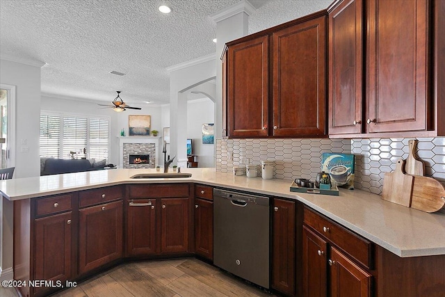 kitchen with dishwasher, sink, backsplash, kitchen peninsula, and crown molding