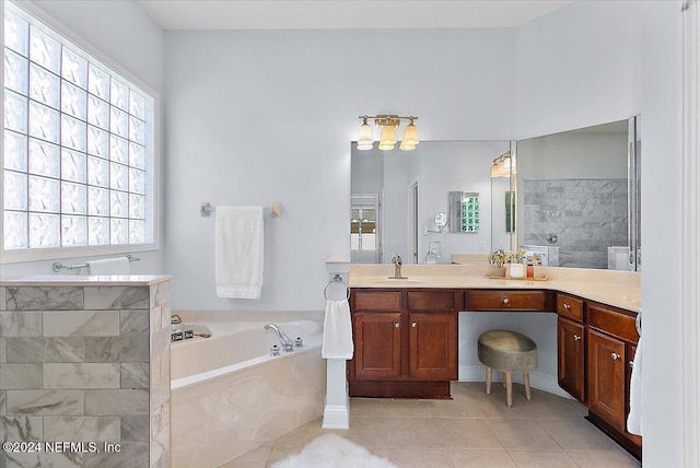 bathroom featuring shower with separate bathtub, vanity, and tile patterned flooring