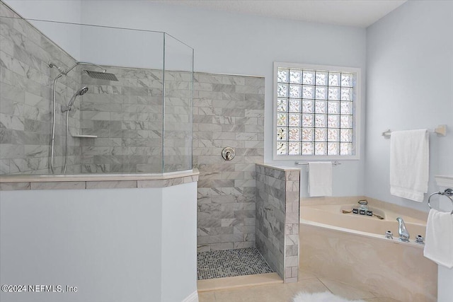 bathroom with independent shower and bath and tile patterned flooring