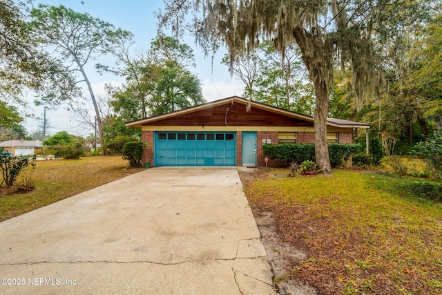 single story home with a garage and a front lawn