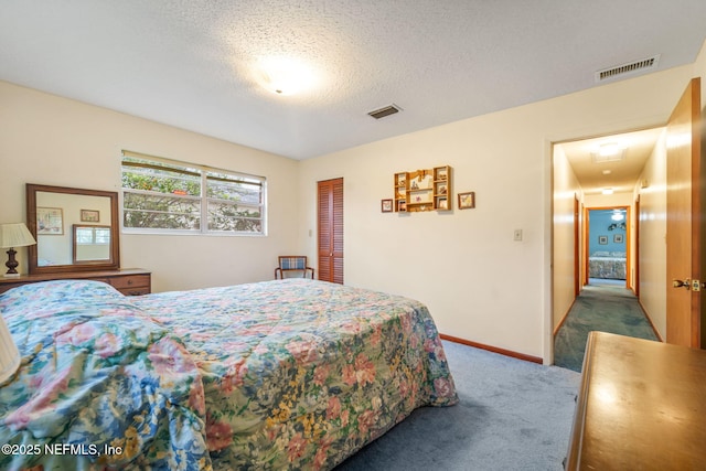 bedroom featuring a textured ceiling and carpet