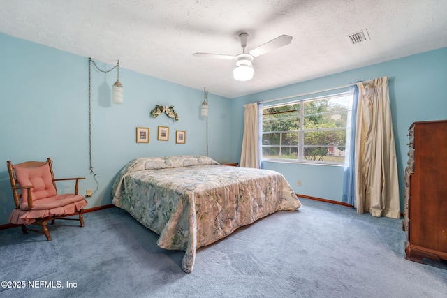 bedroom featuring ceiling fan, carpet, and a textured ceiling