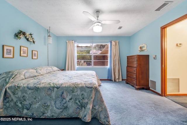 carpeted bedroom featuring a textured ceiling and ceiling fan