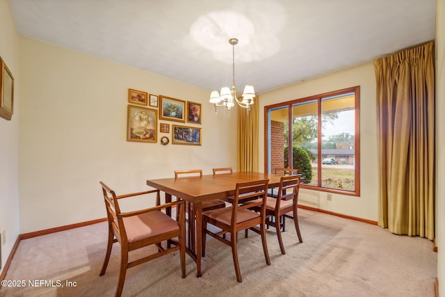 dining room featuring light carpet and a notable chandelier