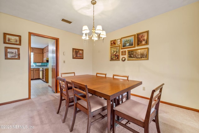 dining room featuring a notable chandelier and light colored carpet