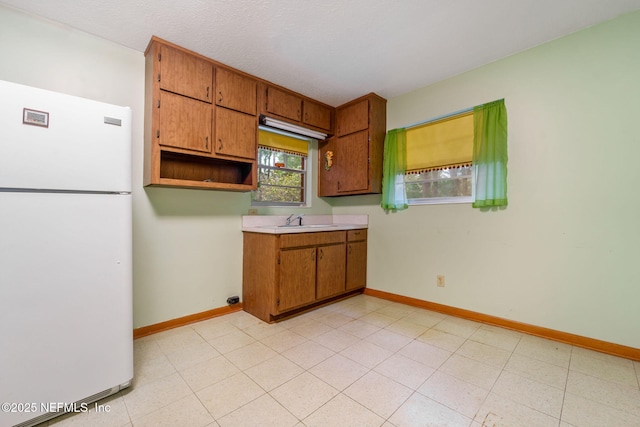 kitchen with sink and white fridge