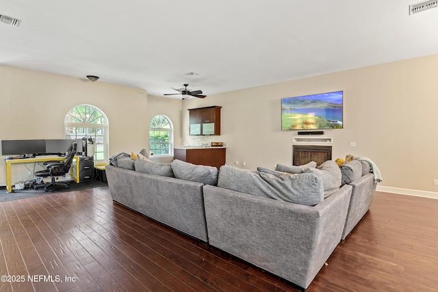 living room with ceiling fan and dark hardwood / wood-style floors