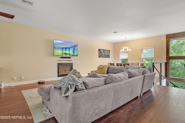 living room featuring dark hardwood / wood-style flooring and an inviting chandelier