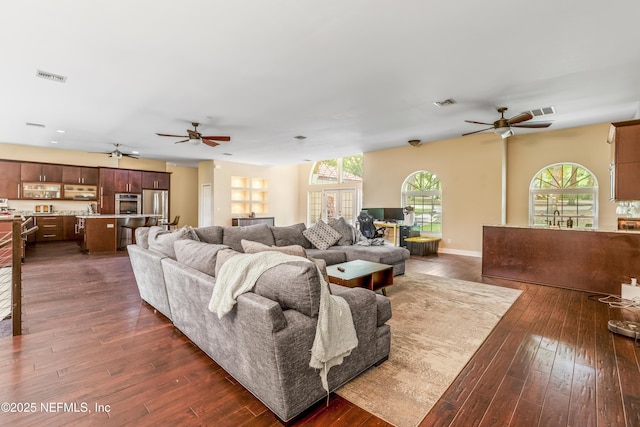 living room featuring sink, dark wood-type flooring, and ceiling fan