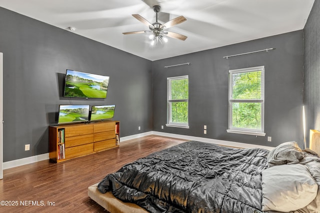 bedroom with dark wood-type flooring and ceiling fan