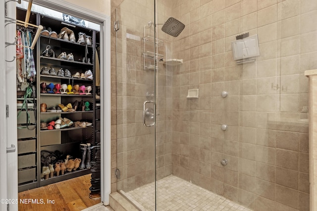 bathroom featuring wood-type flooring and an enclosed shower