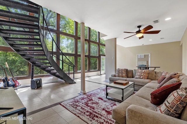 living room with light tile patterned floors and ceiling fan