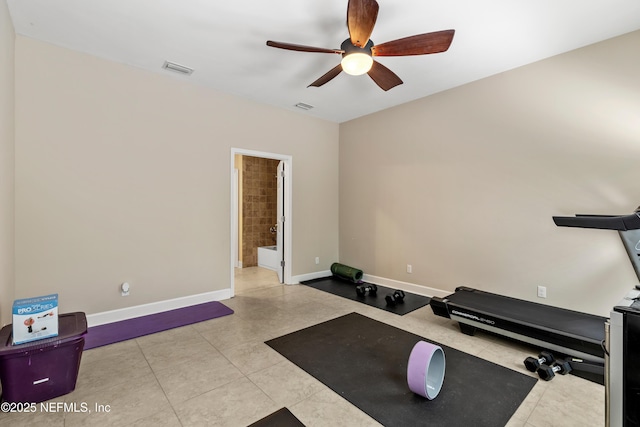 workout room with light tile patterned flooring and ceiling fan