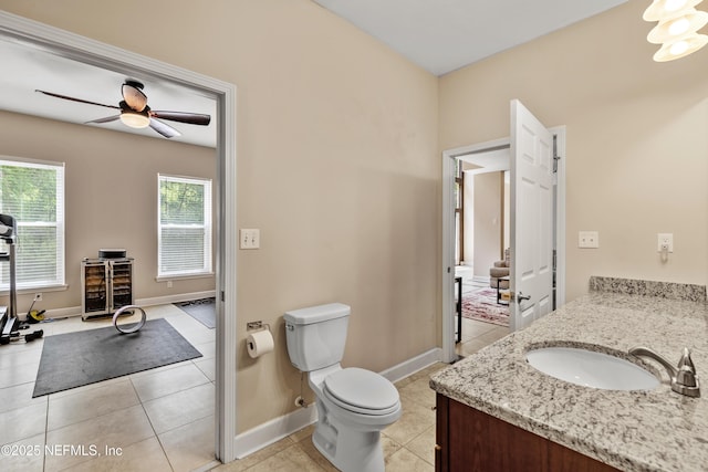 bathroom featuring wine cooler, toilet, vanity, ceiling fan, and tile patterned flooring