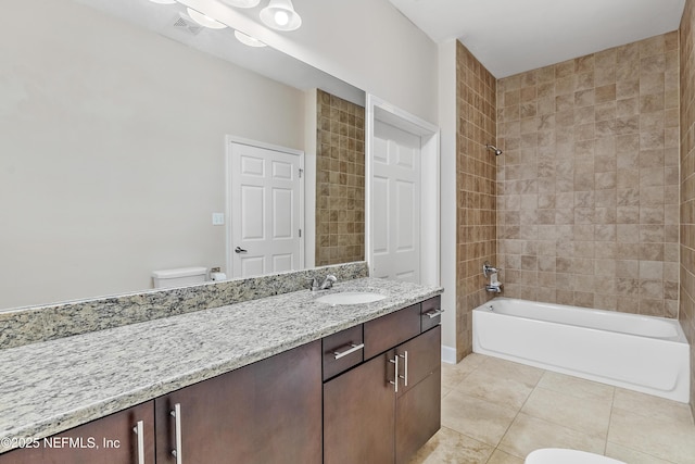 full bathroom with vanity, tile patterned flooring, tiled shower / bath combo, and toilet