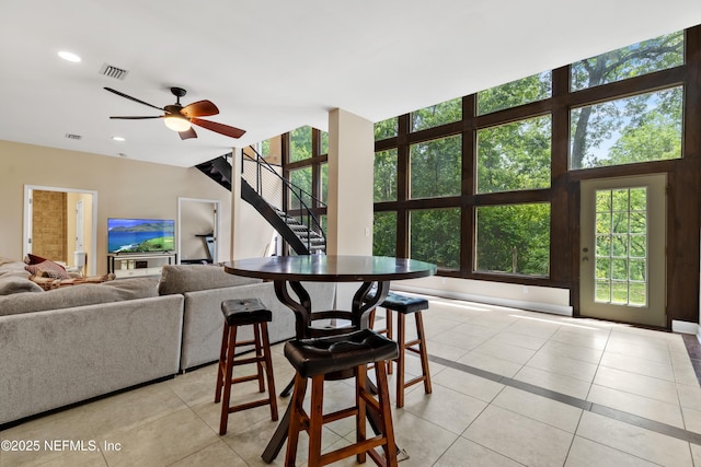 tiled living room featuring ceiling fan