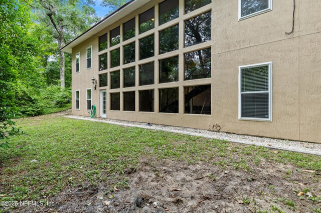 view of property exterior with a lawn