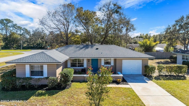 ranch-style house with a garage, a front yard, and covered porch