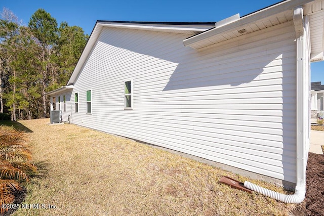 view of property exterior featuring a yard and central air condition unit