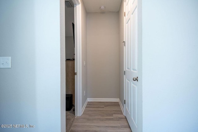 hallway with light hardwood / wood-style flooring