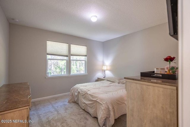 carpeted bedroom featuring a textured ceiling